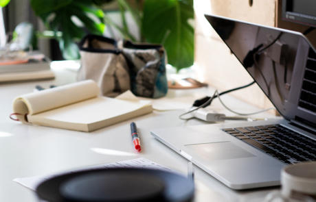 Sales and Marketing desk with notepad laptop red pen stock column