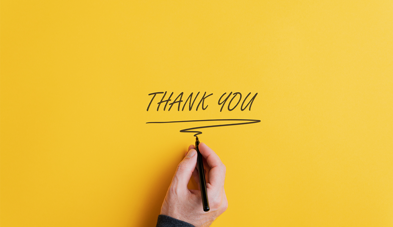 Male hand writing thank you sign column width