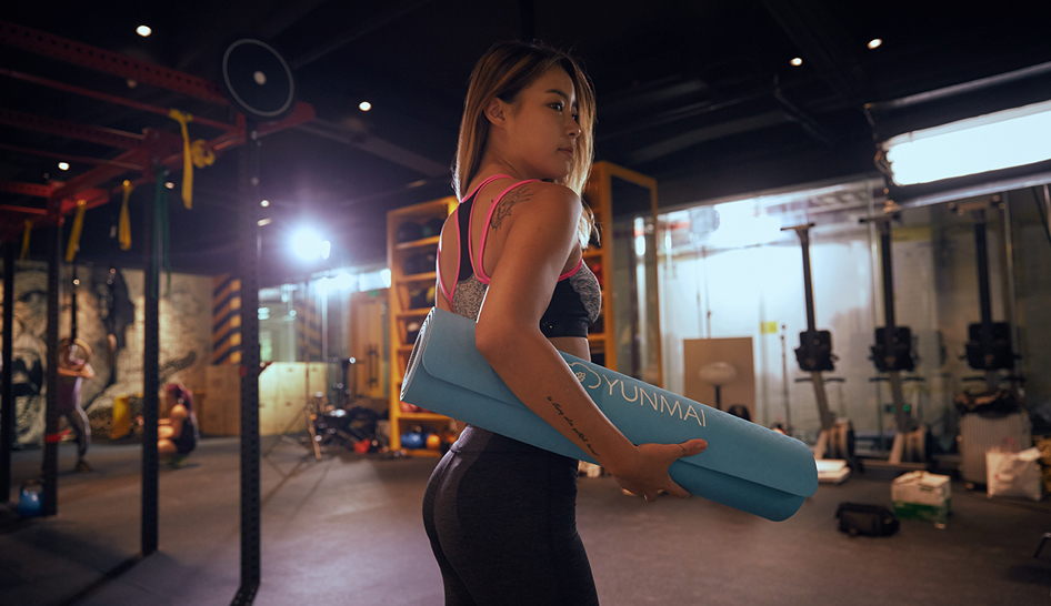 Woman In Gym With Yoga Mat Column Width